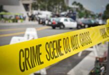 Daylight Bronx Horror — School Aide Down crime scene tape stretches across a blocked city street