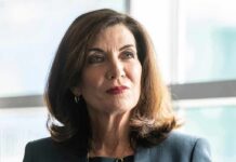 Hochul’s Whiplash: ICE Help, Then Handcuffs woman in business attire looking to the side