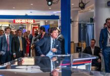 Angel Studios Cornered—Carlson Fallout News anchor at a studio desk with crowd and cameras in background