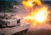 tank firing main gun with bright muzzle flash