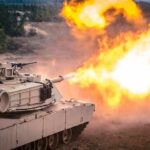 Abrams Upgrade Scrapped After Price Shock tank firing main gun with bright muzzle flash