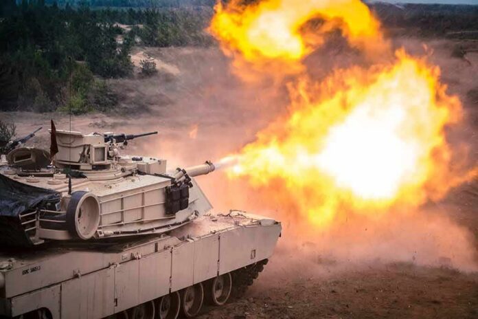 shutterstock_2253800619 tank firing main gun with bright muzzle flash