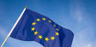 European Union flag waving against blue sky