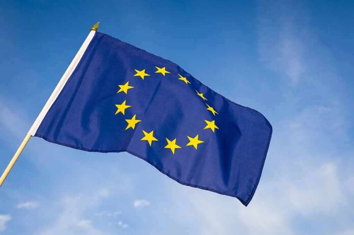 shutterstock_525917890 European Union flag waving against blue sky