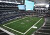 Massive Payday Locks Dallas’ Defensive Hammer American football stadium interior with large central video board