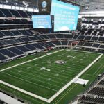 American football stadium interior with large central video board