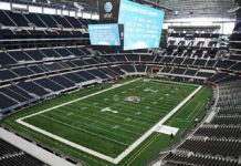 Massive Payday Locks Dallas’ Defensive Hammer American football stadium interior with large central video board