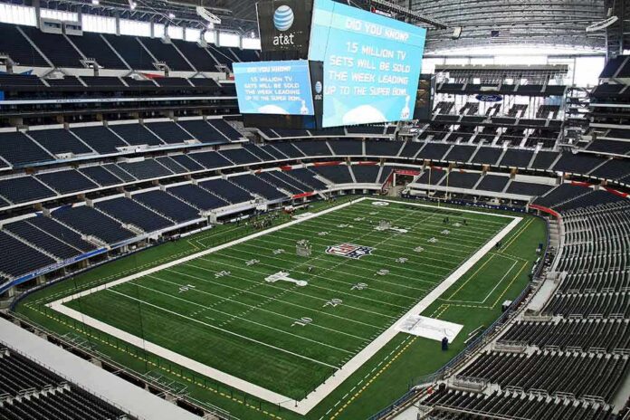 American football stadium interior with large central video board