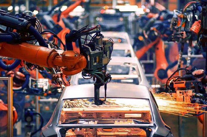 Industrial robots welding a car body on an assembly line
