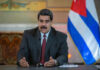 One Title Could Upend Maduro’s Prosecution Man speaking at podium with Cuban flag in background.