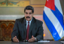 One Title Could Upend Maduro’s Prosecution Man speaking at podium with Cuban flag in background.