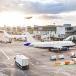 One Flight Triggered a Full-Blown Security Scare Airplanes at airport gates during sunset with ground vehicles and jet bridges