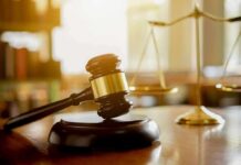 Arraignment Looms: Disturbing Claims Rock Influencer Judge's gavel on a block with scales of justice in the background