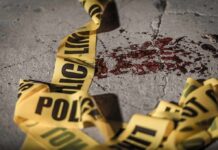 Home Invasion Horror: Doctor Down Crime scene tape near blood on pavement