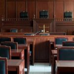 Empty courtroom with wooden benches and judge's bench