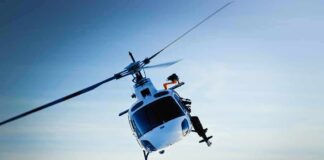 helicopter banking over snowy mountains