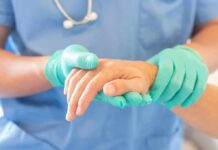 Euthanasia Shock: Consent Vanished? Healthcare worker in gloves holding a patient's hand