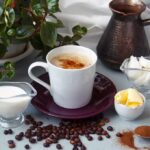 Older Women Beware: Coffee’s Bone Trap Cup of coffee with milk, butter, and spices on a table