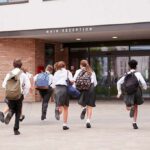 Disturbing Yearbook Incident Triggers Community Backlash Students in uniforms running toward a school entrance