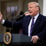 Rose Garden Cheers, Comment Section Burns Donald Trump speaking at a podium outdoors