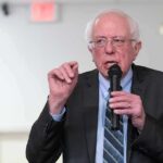 Campaign Surrogate Or “Just A Podcaster”? Elderly man speaking into a microphone