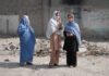 Abduction Pipeline Exposed in Pakistan Three women in traditional attire standing in an urban setting with debris in the background
