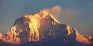 Snow-capped mountain peak glowing at sunrise