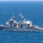 Gray naval warship cruising on open sea