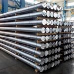 Missile Shortage Shock Triggers 21-Day Ultimatum Stacked metal rods on pallets in an industrial warehouse