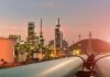 Trump’s Pause Collides With Drones Oil refinery with pipelines at sunset