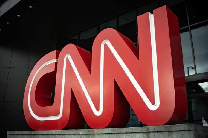 Large red CNN logo outside a modern building entrance