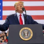 Primetime Snub Ignites FCC Showdown Donald Trump speaks at a podium with U.S. flag backdrop; Christian Jones, Caraun Reid, and Bill Bergey in crowd