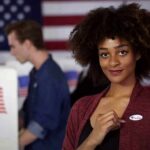 Socialist Surge Upends Florida Map Voter showing an I Voted sticker at a polling place