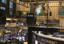 Wall Street Punished Growth Over A Tiny Miss NYSE trading floor with monitors and tickers