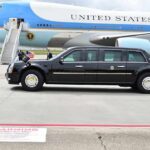 Trump’s Trade Ultimatum — Who Blinks? Presidential motorcade limousine parked beside large blue and white aircraft