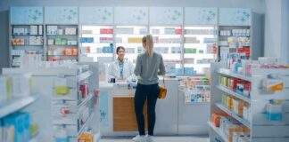 Yvonne Li assisting a customer at a pharmacy counter