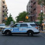 Cops In Camouflage Nail Drivers NYPD police SUV blocking a city street at a taped-off scene