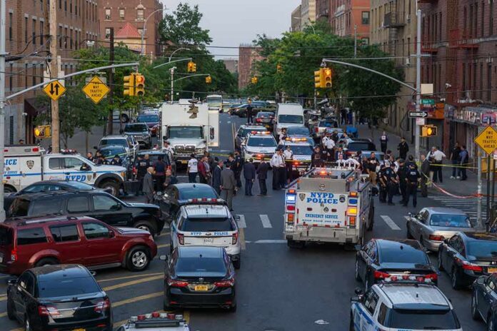 shutterstock_1976471648 Police vehicles and officers block a city street during an active scene
