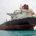 America’s Latest Weapon Doesn’t Fire A Shot Large oil tanker anchored in calm sea