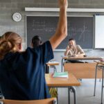 UC Professors Sound Alarms – Shocking Numbers Student raising hand in classroom during lesson