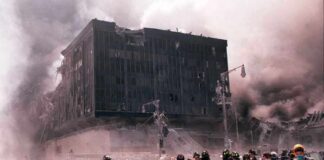 First responders amid debris near a heavily damaged building