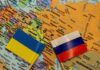 Ukraine and Russia flags on a map of Eastern Europe