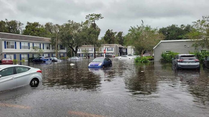 Flooded residential street with partially submerged cars