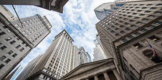 Skyscrapers and a neoclassical building with columns viewed from street level