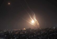 Missile Over Riyadh Sparks Airport Chaos Night sky above a city with multiple rockets arcing and bright explosions