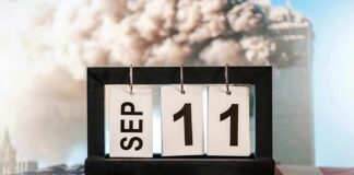 Perpetual desk calendar showing Sep 11 on an American flag