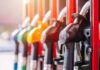 Big Oil Named – What’s Hiding at the Pump? Close-up of fuel pump nozzles at a gas station