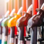 Big Oil Named – What’s Hiding at the Pump? Close-up of fuel pump nozzles at a gas station