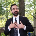 9/11 Stage Stunner Rocks City Hall man in a suit speaking outdoors with hands on chest
