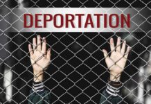 Quiet Policy Upended – Deportations Slowed Hands gripping chain-link fence with deportation sign